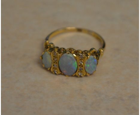 18ct gold three stone opal and diamond ring, opals of good quality and colour, Ring Size O