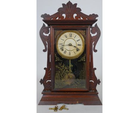 A late 19th century American walnut cased mantel clock with enamel dial and eight day movement by the Seth Thomas Clock Co., 