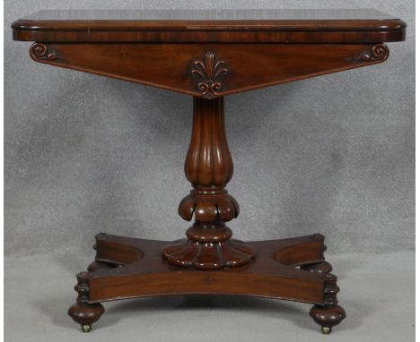 A William IV mahogany foldover top card table with baize lined surface on reeded bulbous pedestal quatreform base. H.73.5 L.9