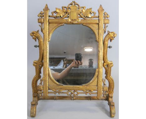 A large late 19th century carved giltwood swing toilet mirror in naturalistic foliate frame with griffin head supports. H.68c