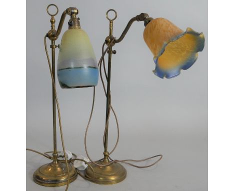 A vintage brass fully adjustable desk lamp with glass shade along with a similar example. H.55cm 
