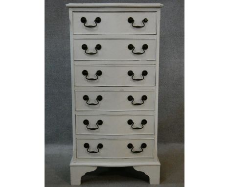 A Georgian style painted narrow chest of six drawers with serpentine front on shaped bracket feet. H.99 W.50 D.37cm 