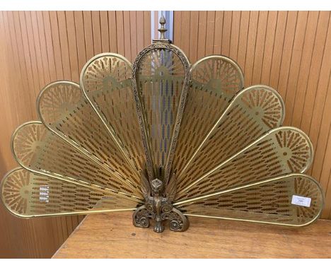A peacock style firescreen with winged beast base measures when open 60x94cm