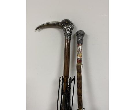 A group of two early 20thc umbrellas, one has a birds head handle with long beak marked with a T and possibly 800 measures 90