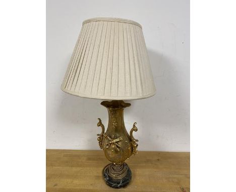 A gilt metal table lamp of rococo inspired form, on marble base and bun feet (a/f) (62cm to top of shade)