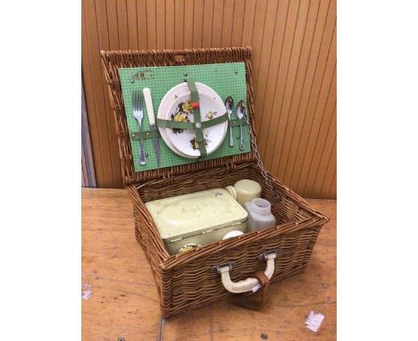 A vintage picnic basket includes two plates, two teacups and saucers, knife, fork etc (a/f) measures 17x36x29cm