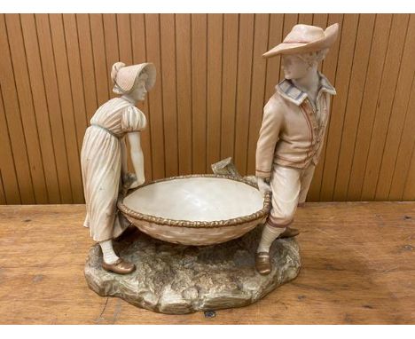 A Royal Worcester figural group of man and woman in hats carrying large basket, chips to gentleman's hat, signature verso Had