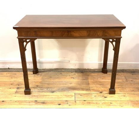 A Chippendale style mahogany side table, rectangular top over figured frieze, raised on blind fret carved square section supp