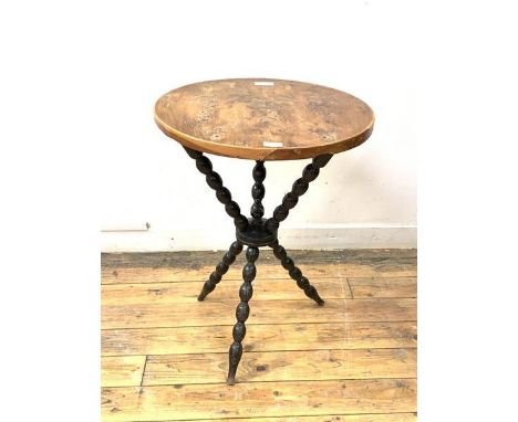 A gypsy table, the circular yew wood top on a bobbin turned ebonised base, H68cm, D52cm