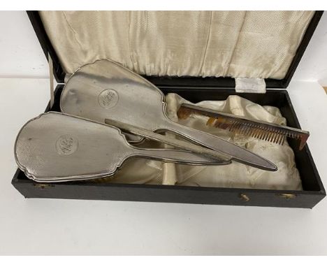 A 1920s silver hand mirror and matching hairbrush with engine turned backs, with two silver comb backs (a lot)