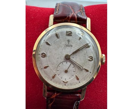 A 1950's Tudor manual wind 9ct gold wristwatch with gold hands and numbers, subsidiary seconds dial on 9ct gold Rolex case ma