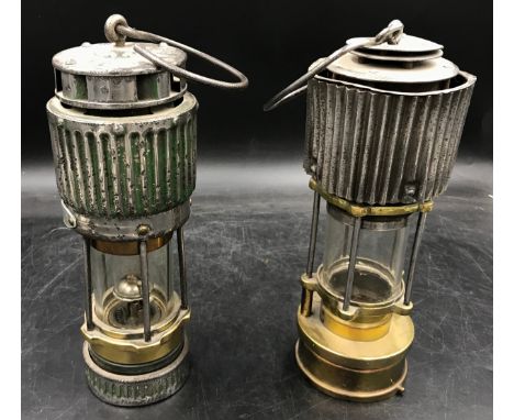 Two miner's safety lamps both with corrugated effect upper bodies, tallest 28cm high, one with Type HCP Patterson Lamp Ltd on