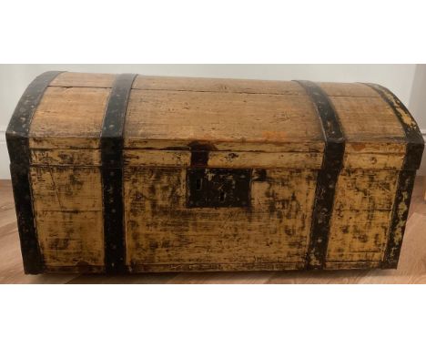 A 19thC pine and metal domed topped trunk with carrying handles. 78 l x 44 w x 40 h. 