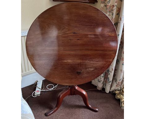 An early 19thC mahogany tip top tripod table with reeded column. 