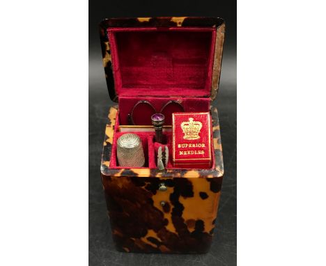 A tortoise shell etui sewing kit in a square shaped form with a small engraved cartouche to top containing the sewing equipme