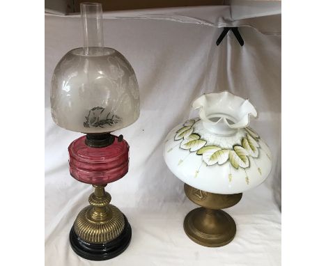 Paraffin oil lamp, with cranberry coloured reservoir, etched shade on brass base, circular moulded black base, overall 63cm h