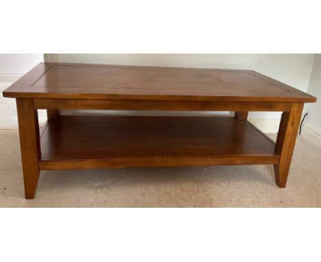 A 20thC coffee table with shelf. 125 l x 60 w x 47cm h.