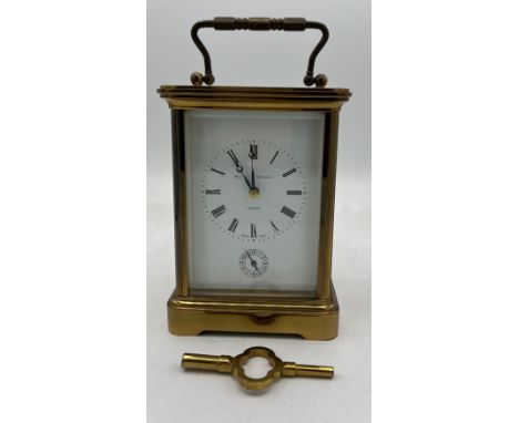 A Matthew Norman brass carriage clock with key. 13.5cm h without handle. 