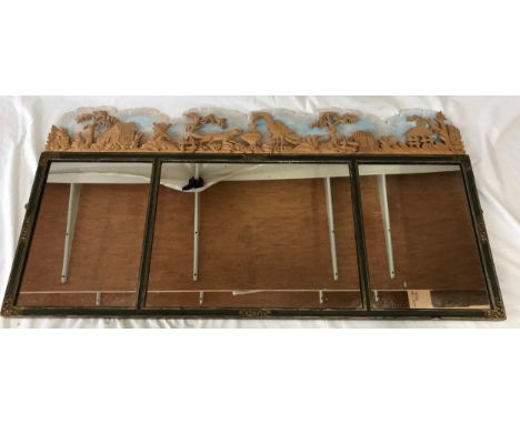 A large mirror in three sections with a carved wooden decoration to top of huts and animals by Douglas Brickwood, Specialist 