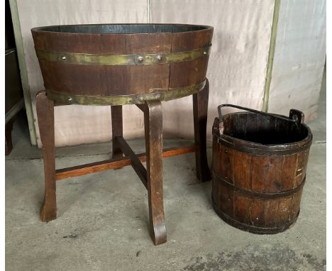 A coopered oval wooden planter 56cm x 43.5 x 62 h. with metal liner together with a wooden bucket. 