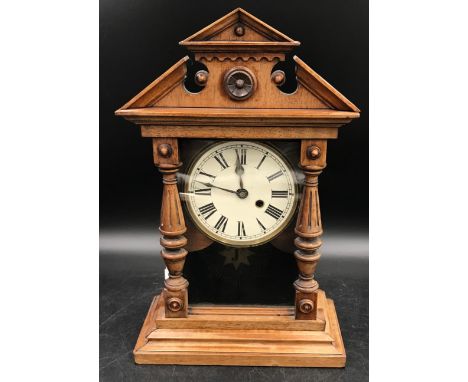 An oak mantle clock by J Unghans face with roman numerals 