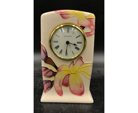 A Moorcroft mantel clock with  flower decoration. 