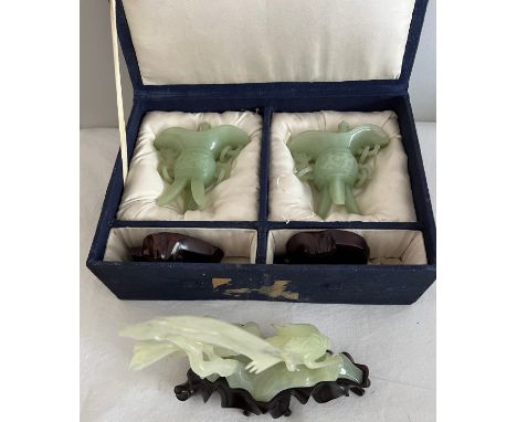 A pair of jade vases on wooden stands in original fitted box together with a figure of two birds on a carved wooden stand. 17