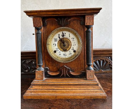 An oak cased mantle clock by Fattorini &amp; Sons, Bradford with white enamel face. Key and pendulum present. 