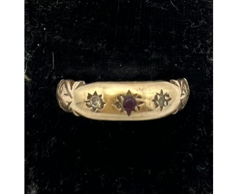 A 9 carat gold ring set with clear and red stone. Size R. Weight 2.6gm. 