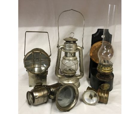A selection of lamps to include a Feuer Hand hurricane lamp, 25 cm h excl handles, an A J. Hinks &amp; Son wall mounted paraf