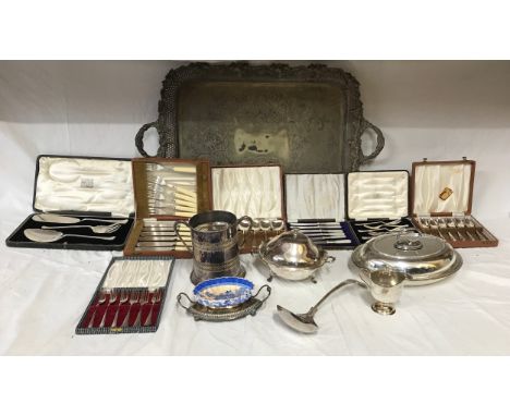 A collection of silver plate items to include a large ornate serving tray on raised feet 74.5 x 46cm, a ladle, jug, large two