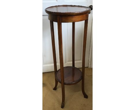 A mahogany torchiere with lower shelf and decorated edging to top,  93cm h x 35cm diameter. 