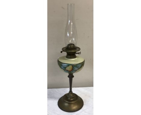 Paraffin table lamp with decorated yellow bowl on brass support and base with chimney but no shade. 