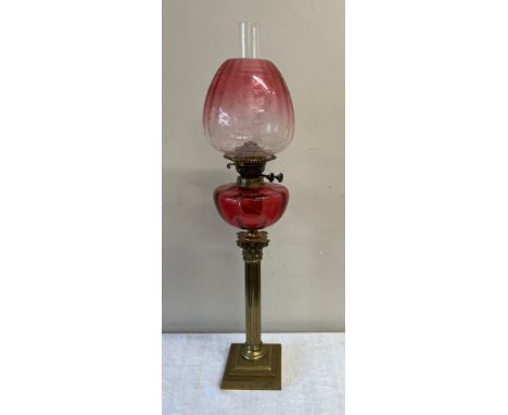 A 19thC oil lamp with brass Corinthian column base and cranberry bowl with etched cranberry glass shade. Height 80cm h.