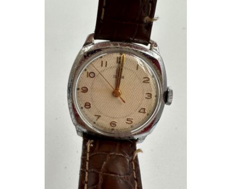 A 1950's gentleman's Tudor cushion wristwatch on brown leather strap and Rolex buckle. Dennison case inscribed 12102 for Role