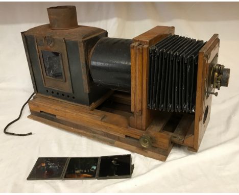 An Antique magic lantern, with sliding projector and bellows, oak-mounted, fitted with electric bulb mechanism, base length 5