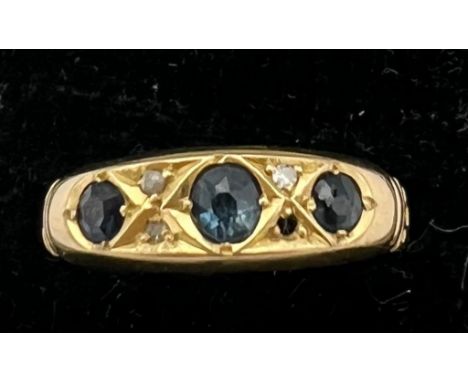 An 18 carat ring set with 3 sapphires and diamonds. One diamond missing. Size R. Weight 2.5gm. 