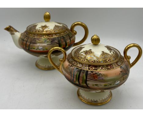 A Nippon hand painted moriage teapot and lidded sucrier. 