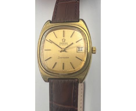 A Vintage gold plated Omega Seamaster automatic wristwatch with date aperture on brown leather strap and Omega buckle. 35mm c