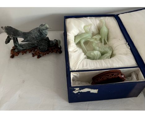 A jade figure of two birds with wooden stand in original fitted case 19 cm h with another bird on carved wooden stand. 