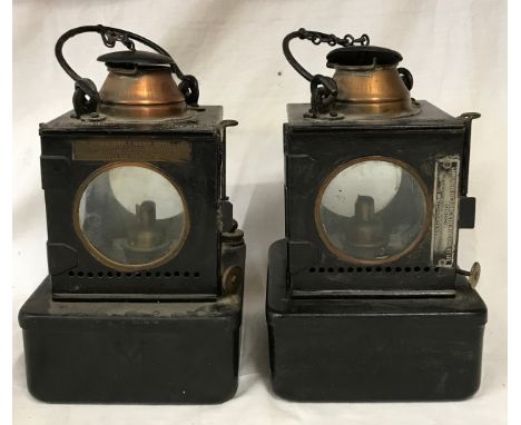 A pair of Midland paraffin lamps with four sided clear glass lens and plaque denoting lamp manufacturing and railway supplies