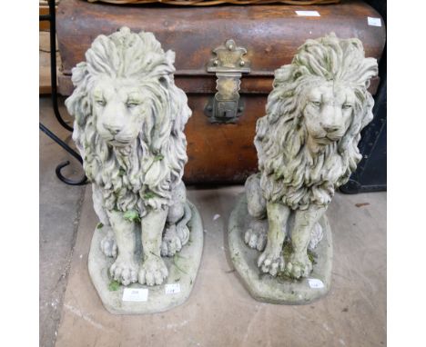 A pair of concrete garden figures of lions 