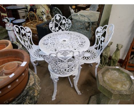 A painted cast alloy garden table and four chairs 