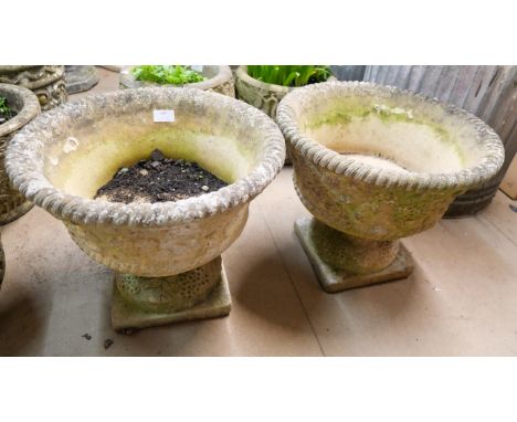 A pair of garden planters on stands 