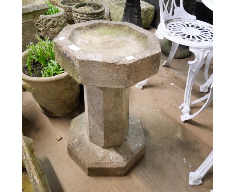 A concrete garden bird bath 
