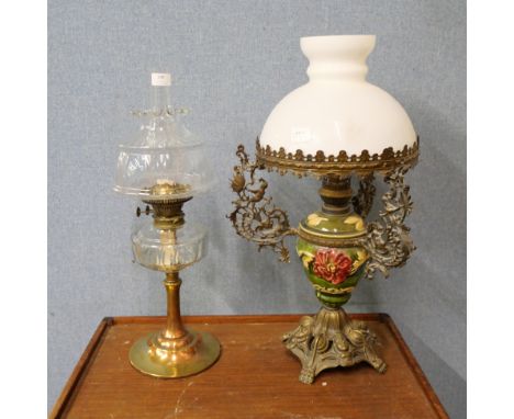 Two oil lamps, one clear glass with brass base and the other with opaque glass shade and ceramic and cast metal base 
