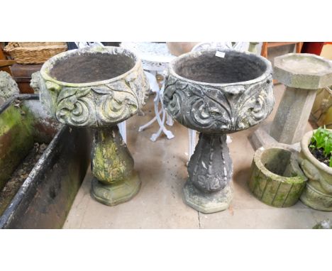 A pair of garden planters on stands 