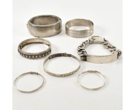 A collection of silver bracelets and bangles and one silver tone metal bracelet. The lot to include a hallmarked silver brace