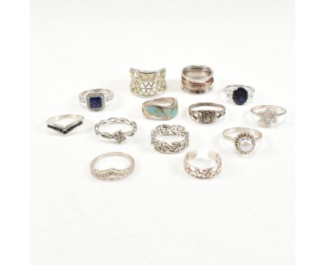 A collection of silver and gem set rings. The rings to include, but not limited to, a large 925 silver lattice ring, a silver