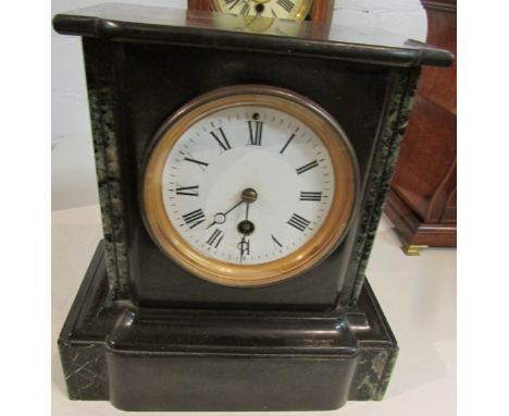 Black slate mantel clock inset with green striated marble, white enamel dial (diameter 9cm) with Roman chapter, inside of bra